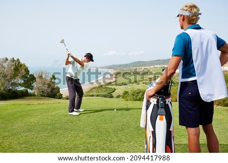 Men playing golf on course Royalty-Free Stock Photo #2094417988