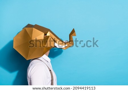 Photo of funky curious guy dressed wild animal mask looking up empty space isolated blue color background Royalty-Free Stock Photo #2094419113