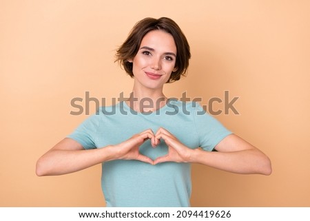 Photo of young pretty woman dream show fingers heart shape romance isolated over beige color background