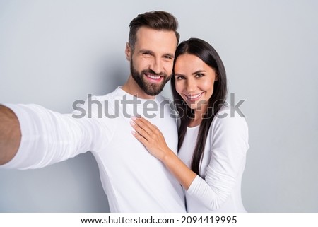 Photo of dreamy cute guy lady dressed white shirts tacking selfie hugging isolated grey color background