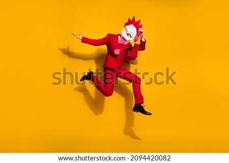 Photo of carefree model guy absurd jump wear cock polygonal mask red tux shoes isolated yellow color background