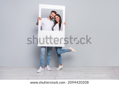 Full size photo of nice young couple do picture wear shirt jeans shoes isolated on grey background