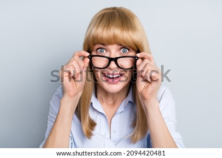 Portrait of attractive cheerful amazed girl hr recruiter assistant touching specs news reaction isolated over grey pastel color background