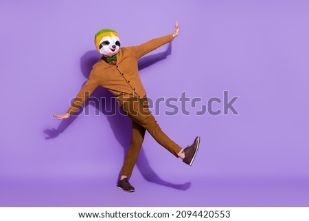 Full body portrait of carefree weird mammal mask guy enjoy dancing clubbing isolated on violet color background