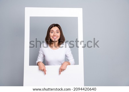 Photo of excited sweet young woman wear white outfit pointing fingers empty space smiling isolated grey color background