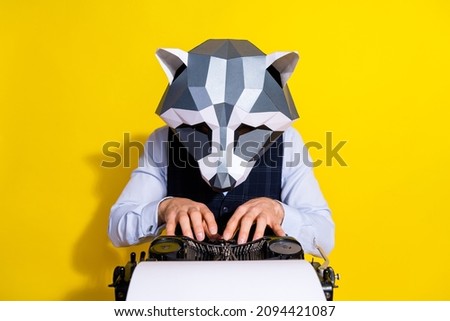Photo of elegant focused unusual guy journalist racoon mask type write machine newspaper blog isolated over yellow color background Royalty-Free Stock Photo #2094421087