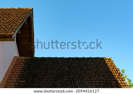 the roof of the house on background of blue sky