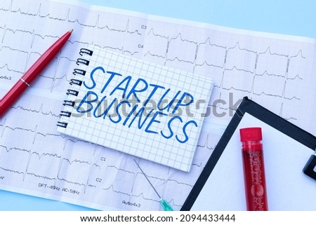 Sign displaying Startup Business. Conceptual photo Engaging to a New Venture Fresh Trading and Selling Reading Graph And Writing Important Medical Notes Test Result Analysis