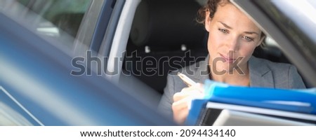 Business woman working in car