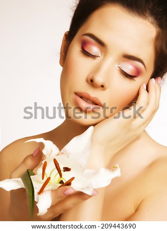beauty young brunette woman with flower close up