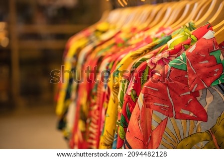 shirt and clothes for olaha summer hanging on a shelf in a designer clothes store