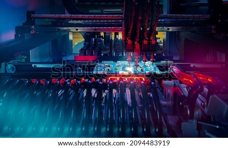 Installation of electronic components on printed circuit board: technology of automated microchip production and computer components. Production of electronic chips and boards on automatic SMT machine Royalty-Free Stock Photo #2094483919