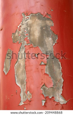 Peeling off paint on the red pillar, closeup of photo