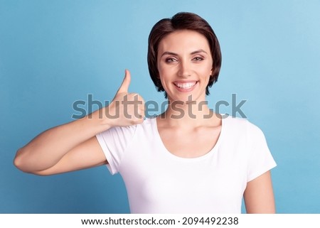 Photo of young cheerful lady promoter show thumb-up approve recommend ads isolated over blue color background