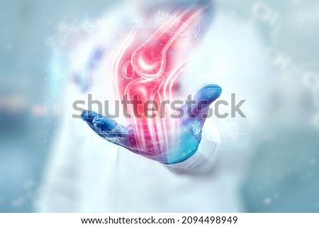 Joint pain, the doctor looks at the hologram of the knee joint. X-ray image, trauma, rheumatologist consultation, skeletal image, medical concept, medical technologies of the future Royalty-Free Stock Photo #2094498949