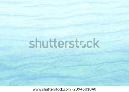 Abstract blue and white surface textured with curve and gradient effect design for backgrounds.