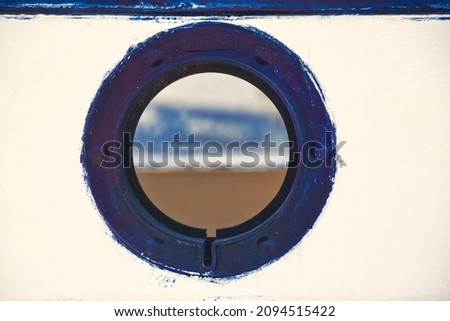small lookout window over a boatman's boat, navy blue and white mediterranean tones, vintage