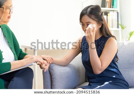 Young Asian woman with depression crying and having consultation session with psychiatrist in mental health service center. Royalty-Free Stock Photo #2094515836