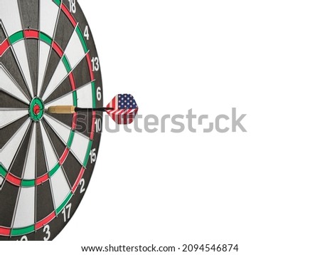 Concept achieving goal.Achieving goals in business, politics and life.Dartboard with darts painted with American flag stuck right into target