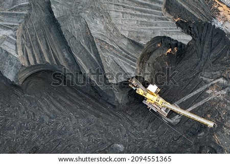 Territory of the coal terminal with coal dumps and a regenerator. loading and unloading of coal by excavators and belt conveyors. coal reserves at thermal power plants. View from above Royalty-Free Stock Photo #2094551365
