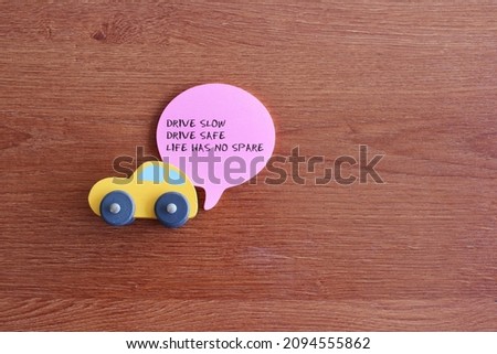 Drive safe quotes concept. Top view of toy car and quotes DRIVE SLOW, DRIVE SAFE, LIFE HAS NO SPARE