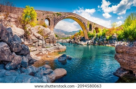 Stunning spring view of Old Mes Bridge. Gorgeous morning landscape of Shkoder. Colorful outdoor scene of Albania, Europe. Traveling concept background. Royalty-Free Stock Photo #2094580063