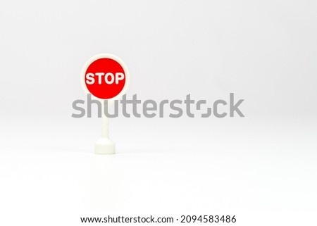 text STOP on red traffic sign on white background