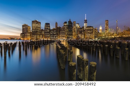New York City skyline with urban skyscrapers at sunset. 