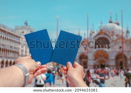 hand holding passports travel concept freedom of movement italy venice