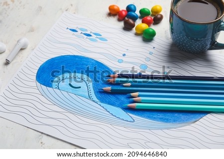 Coloring picture, cup of coffee and pencils on light background