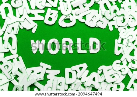 World Environment Day concept, latin inscription. Heap of wooden alphabet letters isolated on green background. Stack decorated quote words text. Creative greeting card title
