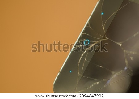 Smartphone with broken display glass. Cracked screen glass. Broken phone. Selective focus