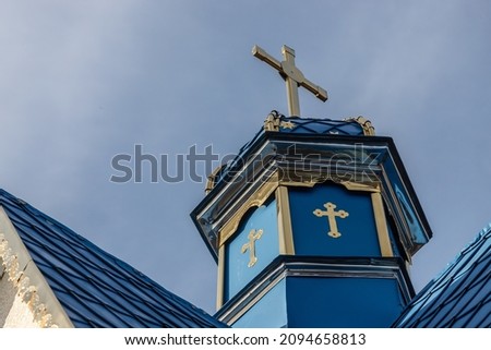 Close-up of a Cross on a Christian church on blue background.