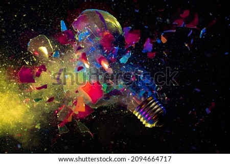 explosion of a colorful light bulb on black. high speed photography. Royalty-Free Stock Photo #2094664717