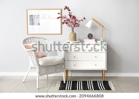 Vase with blossoming branches in interior of modern room