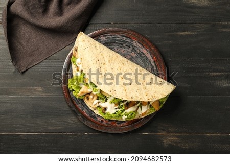 Plate with tasty Fajitas on dark wooden background