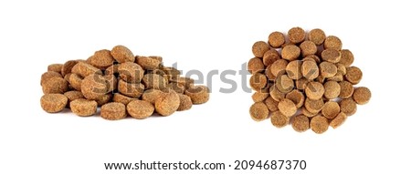 Top view of brown crunchy organic kibble pieces for dog feed heap set isolated on white background. Healthy dry pet food Royalty-Free Stock Photo #2094687370