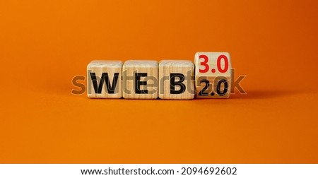 WEB 2 or 3 symbol. Turned a wooden cube and changed words WEB 2.0 to WEB 3.0. Beautiful orange table, orange background, copy space. Business, technology and WEB 2.0 or 3.0 concept. Royalty-Free Stock Photo #2094692602