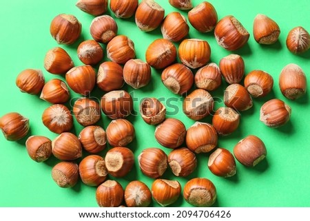 Hazelnuts on color background. Concept of uniqueness