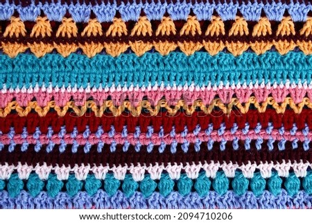 Crochet texture of colored striped knitted fabric Royalty-Free Stock Photo #2094710206