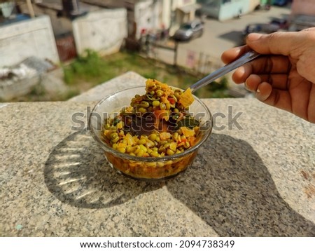 Stock photo of authentic delicious India green gram sprouts curry, dish made with green gram sprouts , onion, tomato, green chillies and curry leaves . Picture captured under bright sunlight at India