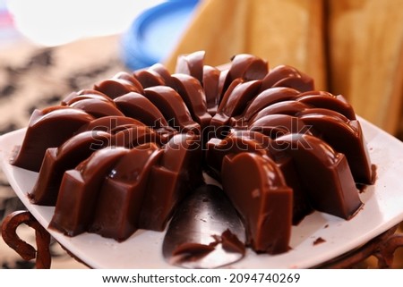 Jakarta Indonesia on December 22, 2021: sliced ​​chocolate pudding, on a plate with iron supports, on the dining table for invited guests. selective focus. defocused