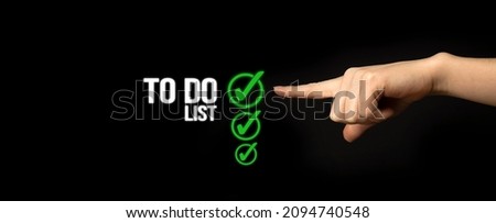 To do list concept. Checklist boxes with green marking on a black background with woman hand, banner