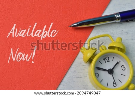 Top view of pen and clock with text AVAILABLE NOW!