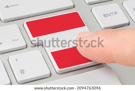 A keyboard with a labeled button - Flag of Austria
