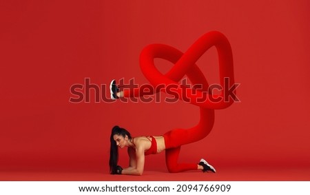 Young girl, fitness coach training on red background. Modern design, contemporary creative art collage. Inspiration, idea, fantasy, surrealism, fashion and style. Copyspace for text or ad. Sport.