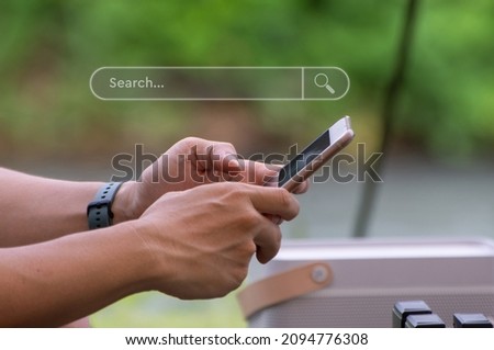 Smartphone in hand to find information and what interests them. Internet search concept
