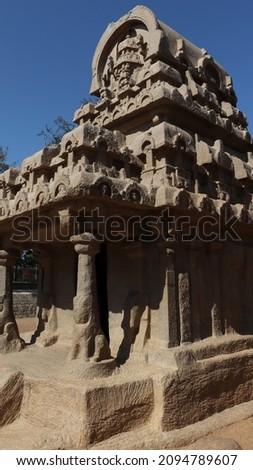 This is called "five rathas" as they resemble the processional chariots of a temple. Statues carved in rock. this is one features in several Hindu scriptures. blue sky backgrounds