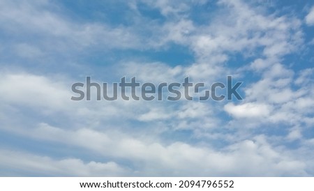 Cloudy blue sky background, horizontal picture. Beautiful blue sky with tiny and soft fluffy clouds after raining. Elegant cloudy blue sky wallpaper background. Landscape image. Texture background