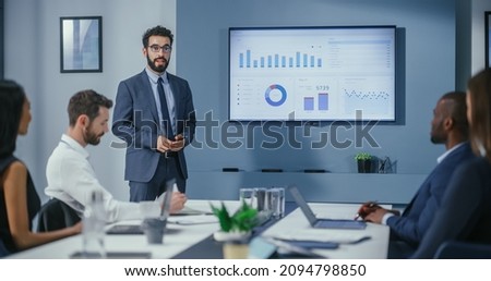 Office Conference Room Meeting: Digital Enterpreneur Presents e-Commerce Investment Strategy for Group of Investors. Wall TV Showing Big Data Analysis, Infographics, Stock Market Information, Trends Royalty-Free Stock Photo #2094798850